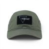 Green tactical hat with black Trijicon hook and loop patch on front